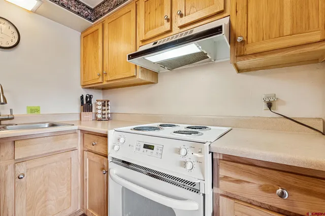 a kitchen with appliances cabinets and a counter top space