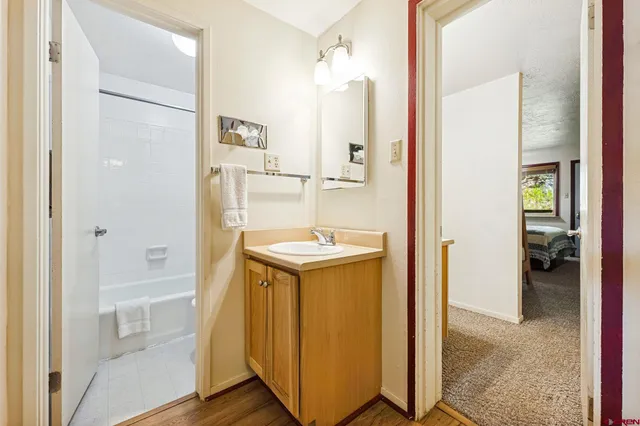a bathroom with a granite countertop sink and mirror