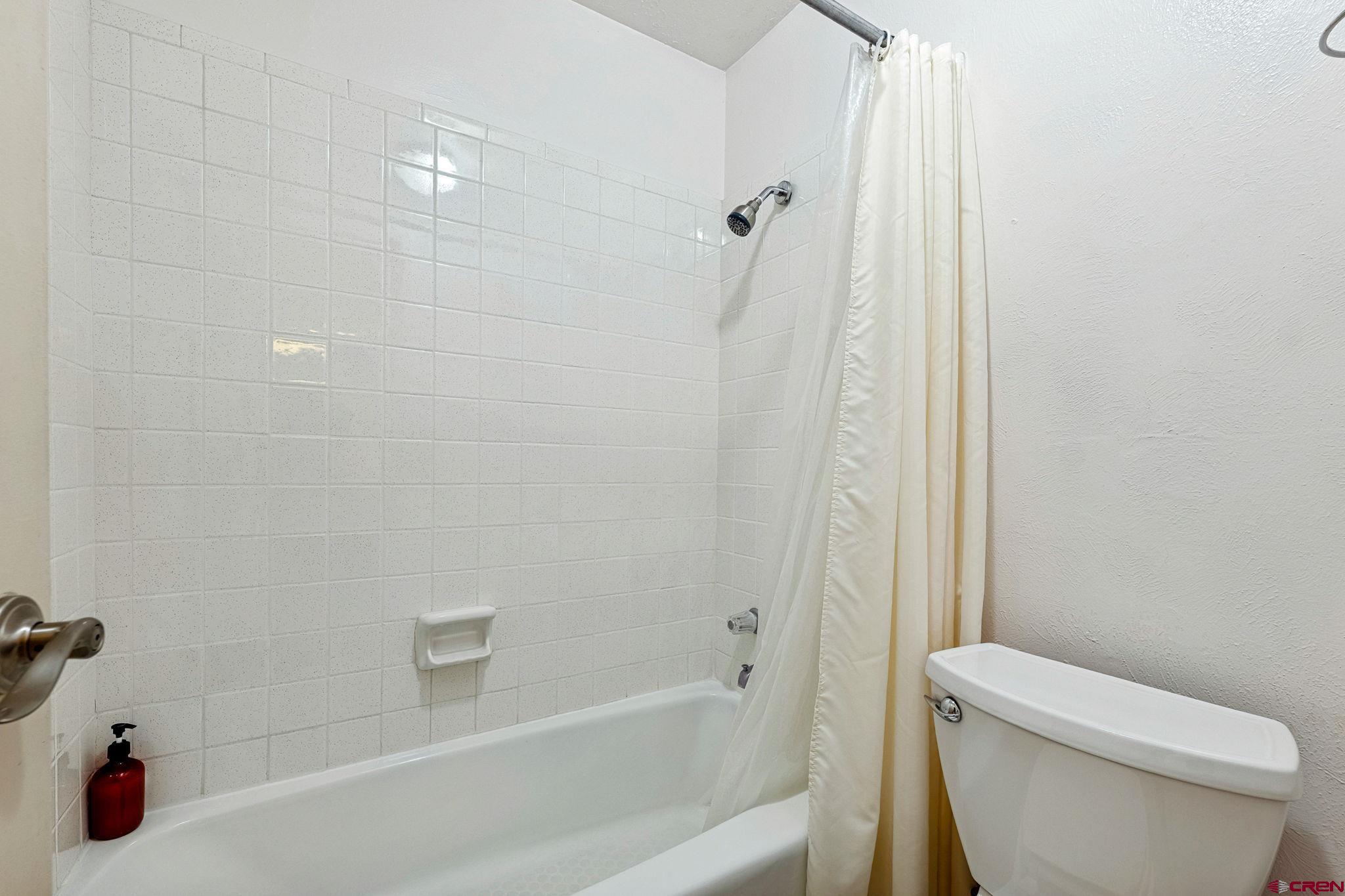 400 Sheol Street, Unit 7 Durango, CO 81301 - Photo 16 of 35 a white bath tub sitting next to a white toilet and sink