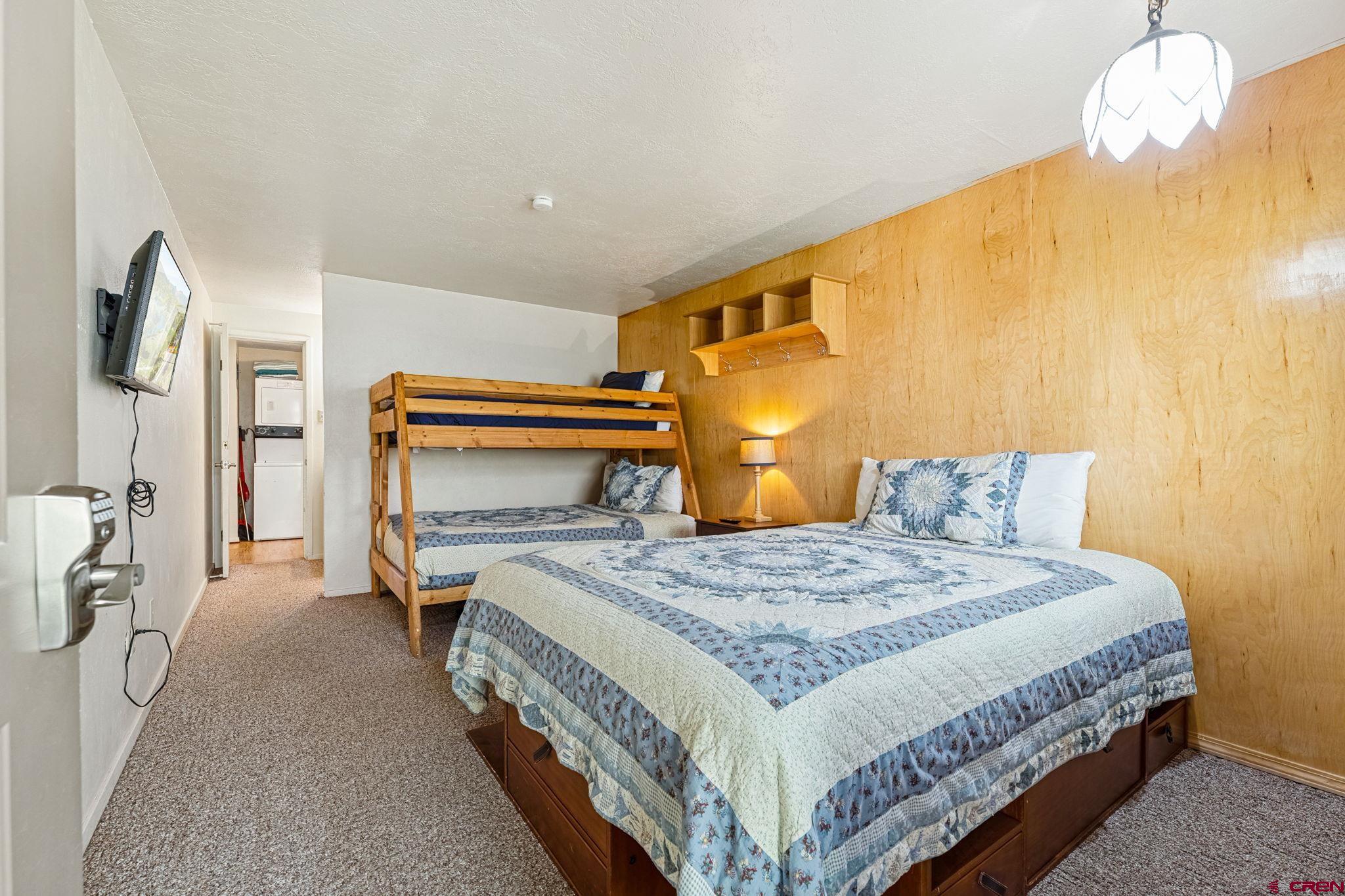 400 Sheol Street, Unit 7 Durango, CO 81301 - Photo 21 of 35 a bedroom with a bed and a chandelier