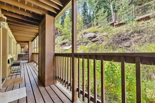 a view of a balcony with wooden floor