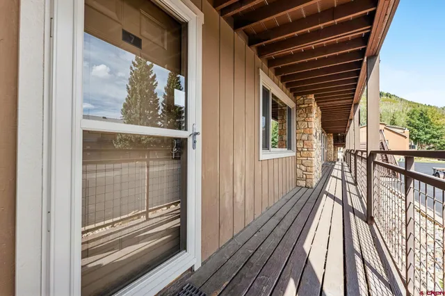a view of a balcony with wooden floor