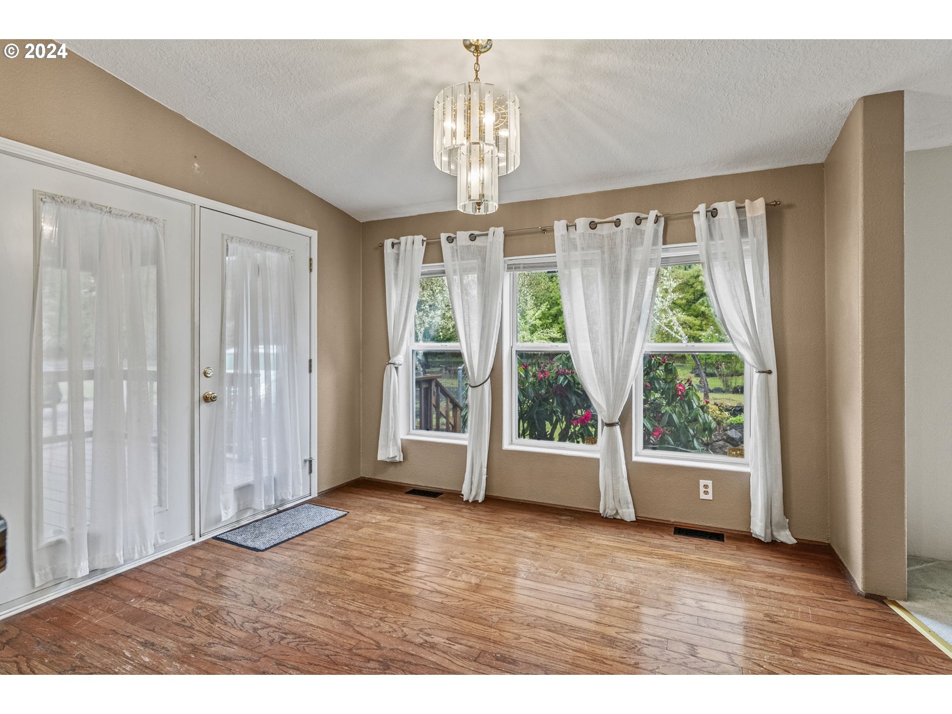 400 Lapham Road Toutle, WA 98649 - Photo 4 of 37 a view of an empty room with wooden floor and a window