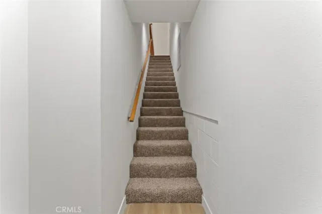 a view of a kitchen with a sink and a refrigerator