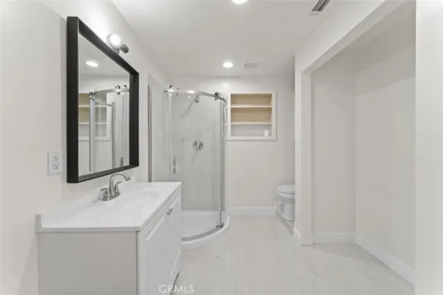 a bathroom with a toilet sink shower and mirror