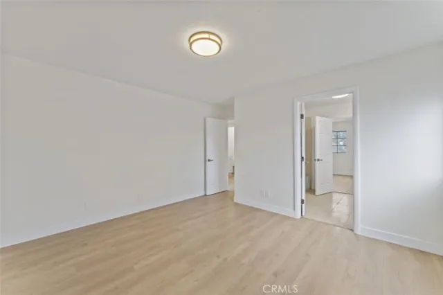 a view of a hallway with wooden shelves