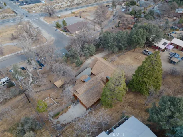 an aerial view of a house with a yard and mountain
