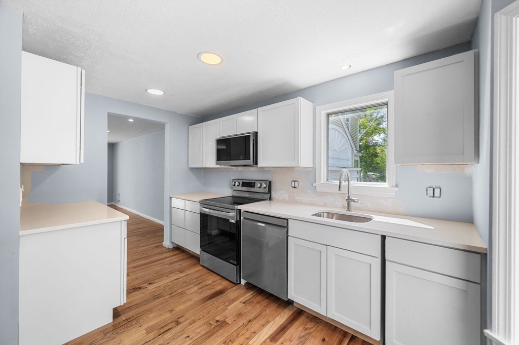 45 Abington Road, Unit 45 Danvers, MA 01923 - Photo 15 of 35 a kitchen with a sink stove top oven and refrigerator