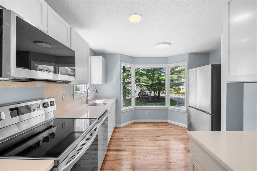 45 Abington Road, Unit 45 Danvers, MA 01923 - Photo 17 of 35 a kitchen with a stove a sink and a microwave