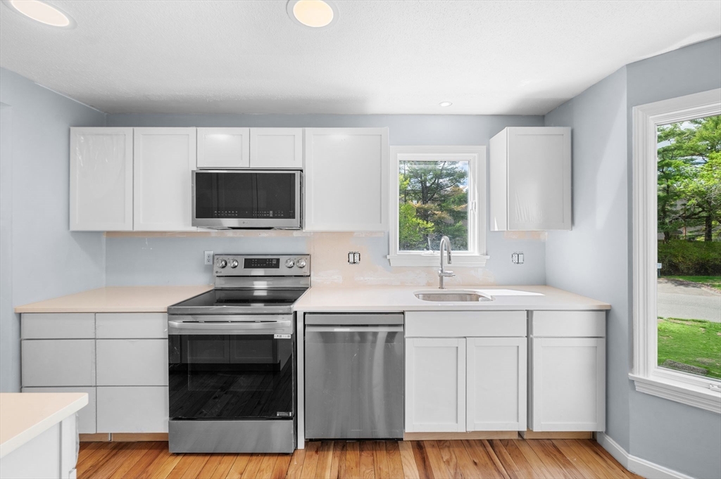 45 Abington Road, Unit 45 Danvers, MA 01923 - Photo 2 of 35 a kitchen with a sink stove and microwave