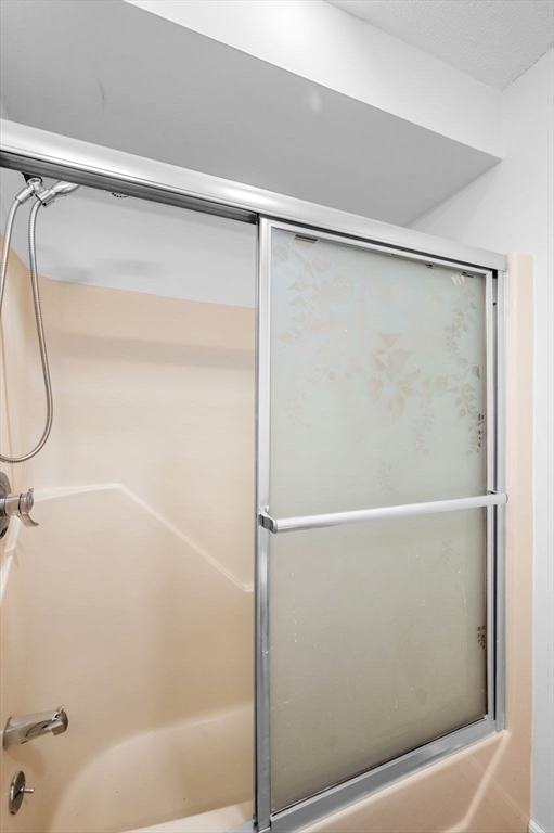 45 Abington Road, Unit 45 Danvers, MA 01923 - Photo 25 of 35 a bathroom with a shower and a glass shower door