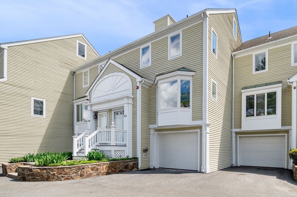 45 Abington Road, Unit 45 Danvers, MA 01923 - Photo 30 of 35 a front view of a house with a yard and garage