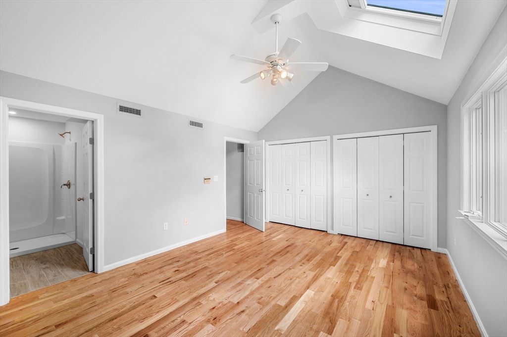 45 Abington Road, Unit 45 Danvers, MA 01923 - Photo 4 of 35 a view of an empty room with wooden floor and a window
