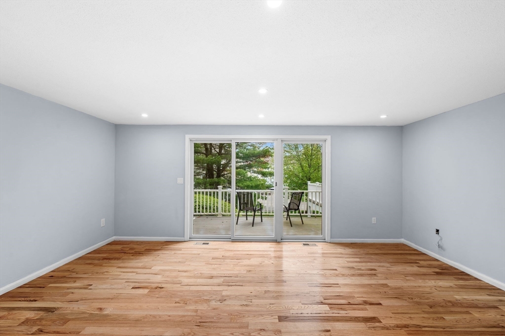 45 Abington Road, Unit 45 Danvers, MA 01923 - Photo 7 of 35 a view of an empty room with wooden floor and a window