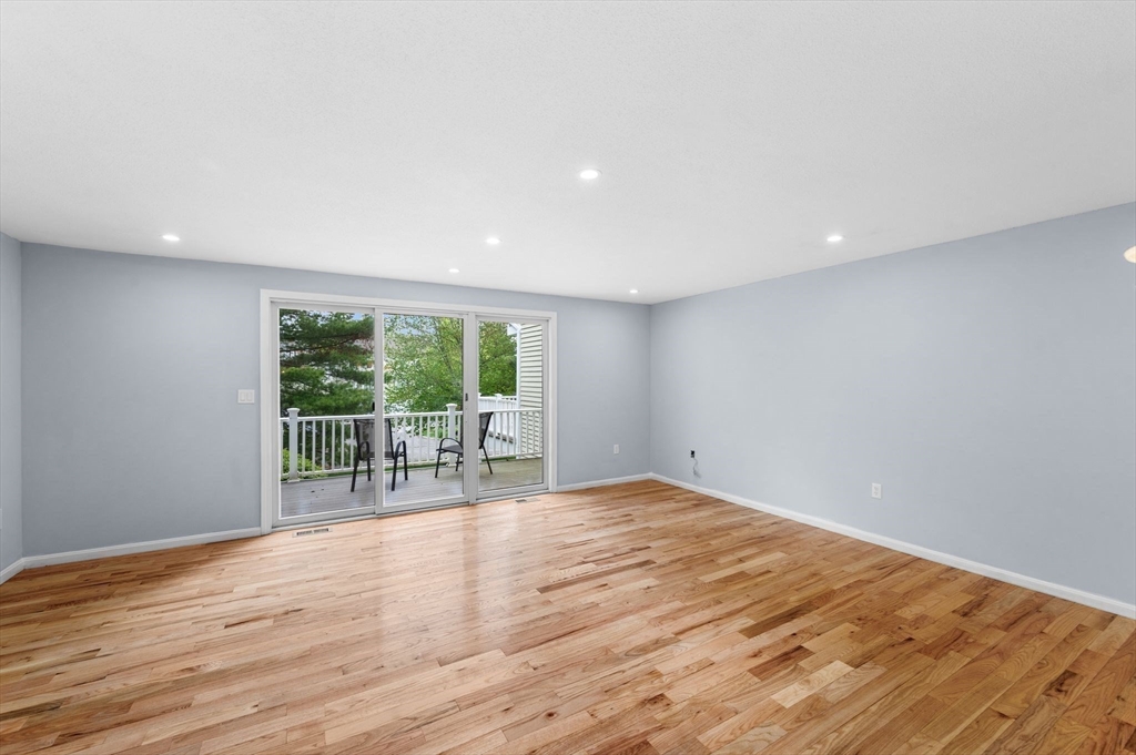 45 Abington Road, Unit 45 Danvers, MA 01923 - Photo 8 of 35 a view of an empty room with wooden floor and a window