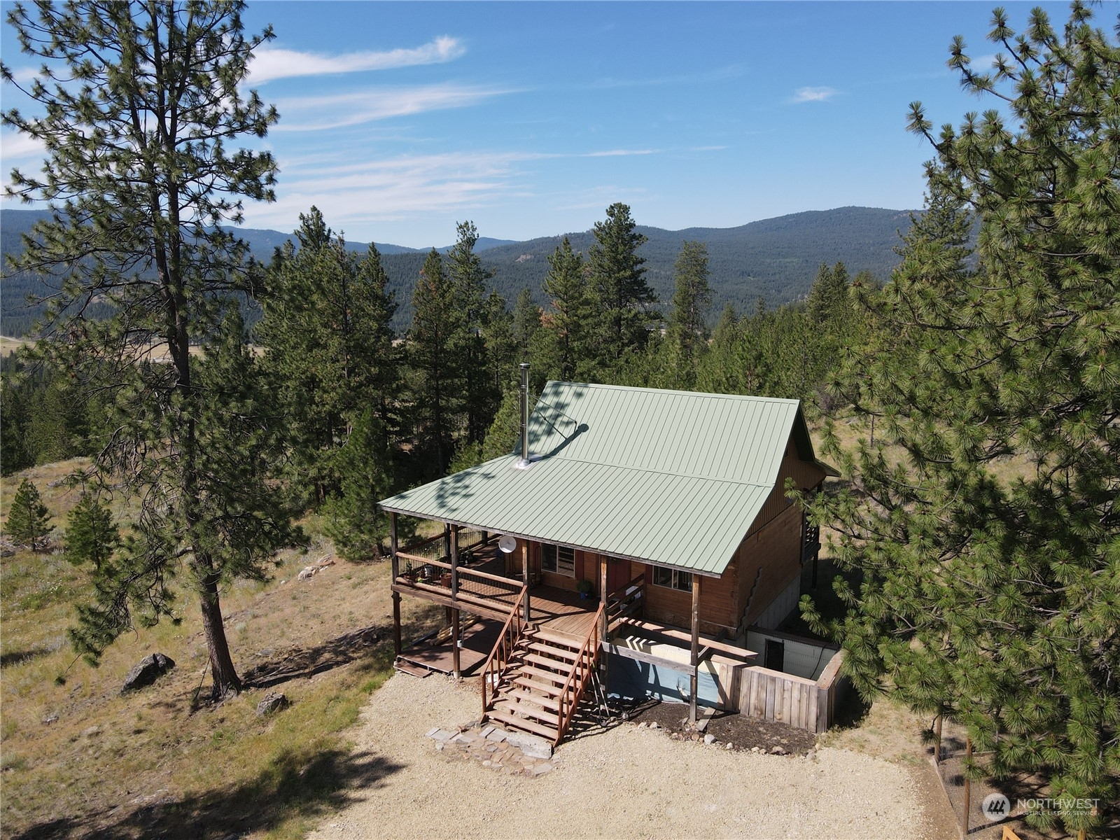 151B Cape Labelle Road Tonasket, WA 98855 - Photo 25 of 33 a view of a patio with a table and chairs under an umbrella