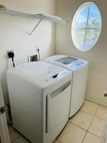 a white toilet sitting next to a shower