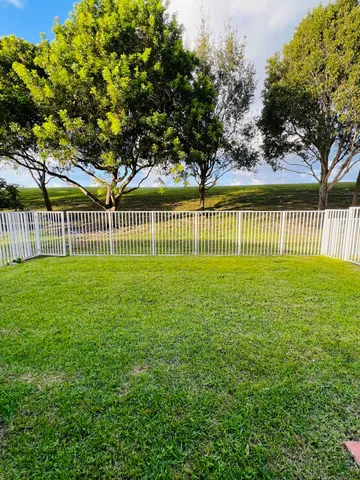 a view of a swimming pool and lounge chairs