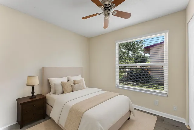 a bedroom with a bed and a window