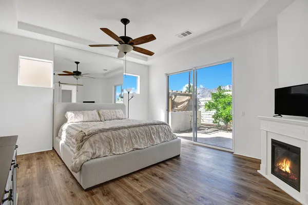 a spacious bedroom with a bed and a fireplace