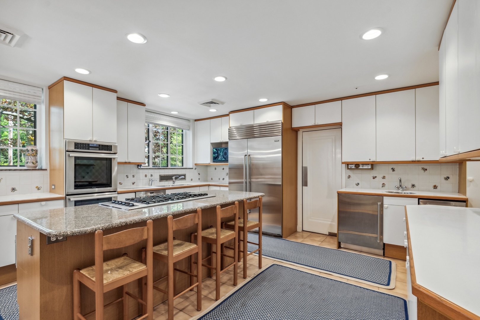 270 Birch Street Winnetka, IL 60093 - Photo 14 of 66 a kitchen with stainless steel appliances kitchen island granite countertop a stove refrigerator and cabinets