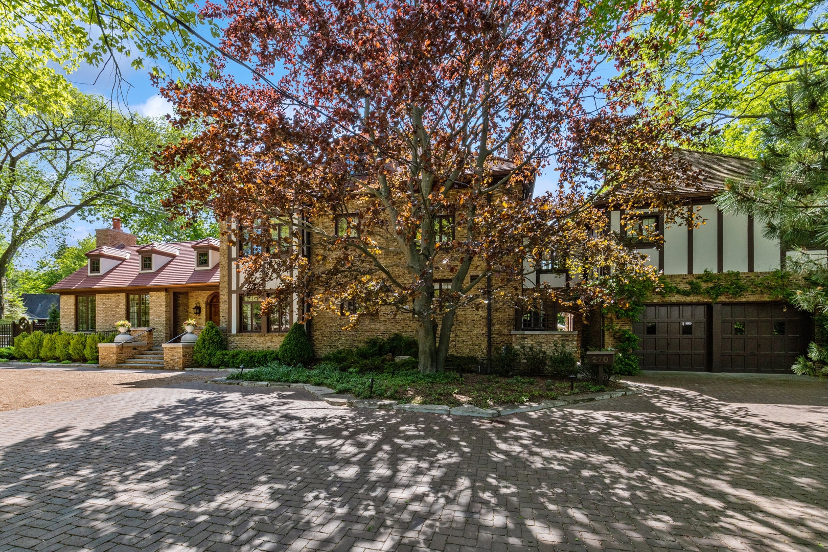 270 Birch Street Winnetka, IL 60093 - Photo 3 of 66 a front view of a house with a garden