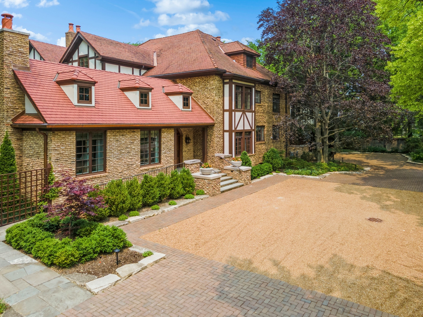 270 Birch Street Winnetka, IL 60093 - Photo 54 of 66 a front view of a house with a yard and potted plants