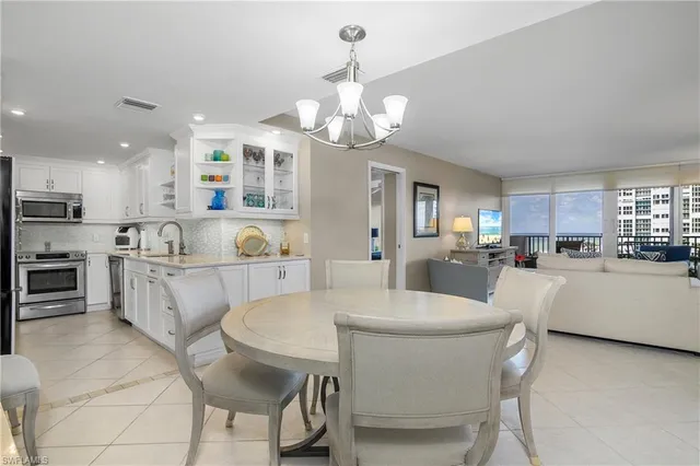 a large kitchen with a table and chairs