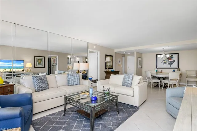 a living room with furniture a rug and a table