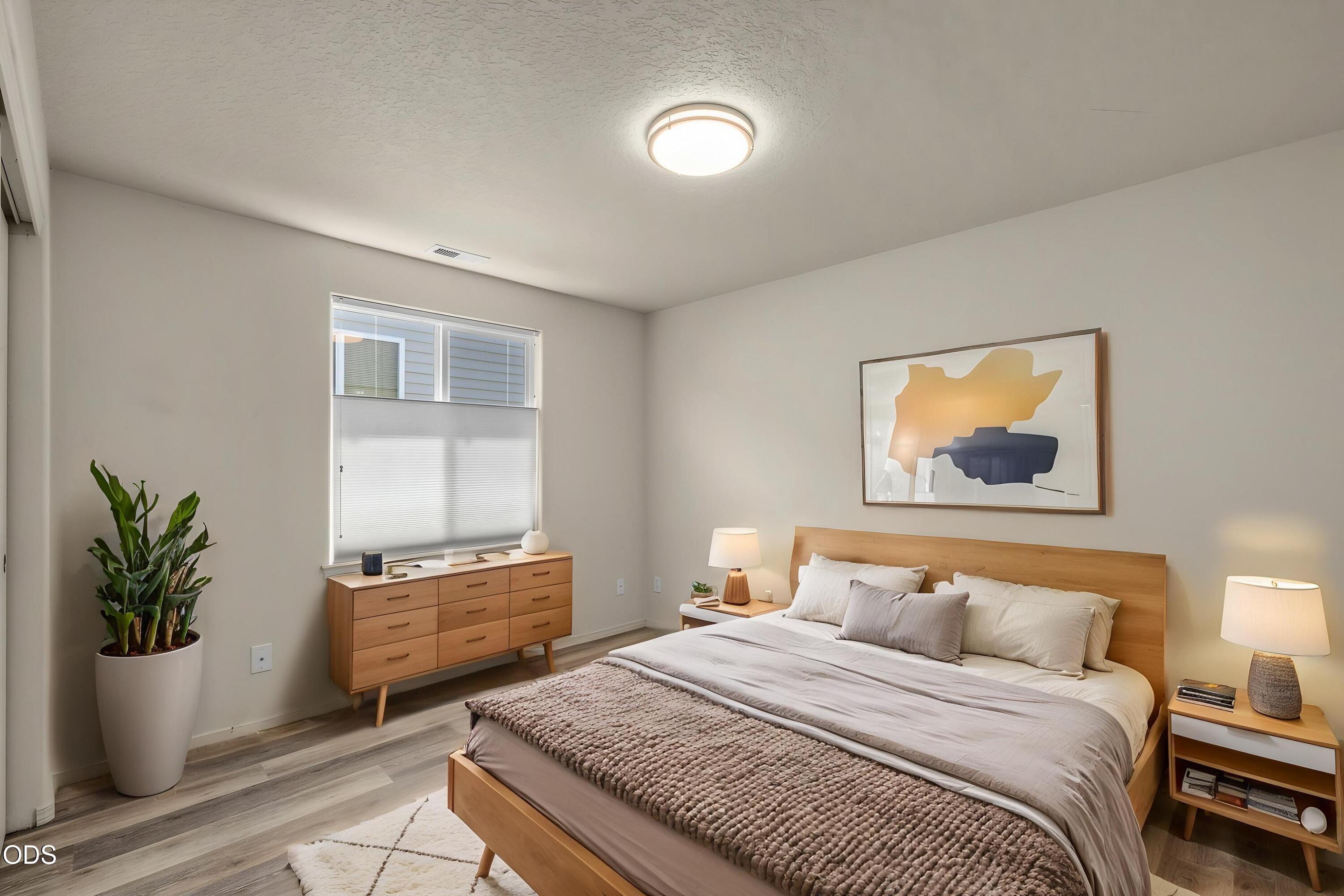 20535 Sunderland Way Bend, OR 97701 - Photo 26 of 41 a bedroom with a bed and a potted plant