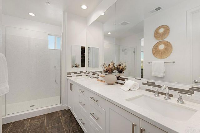 a bathroom with a glass shower door