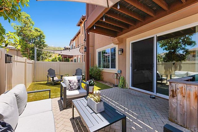 a view of a patio with table and chairs potted plants with sky view
