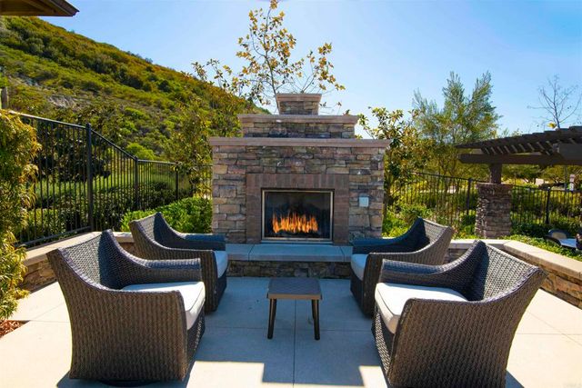 a view of a swimming pool with a patio and a yard