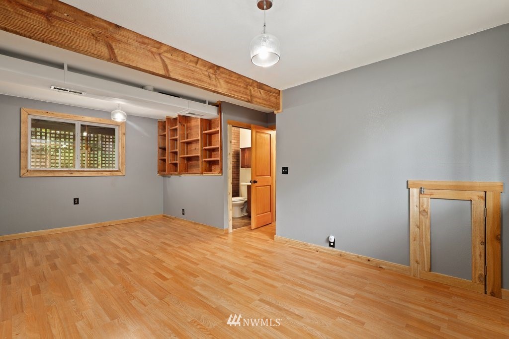 18216 19th Drive Southeast Bothell, WA 98012 - Photo 16 of 37 a view of an empty room with wooden floor and a window