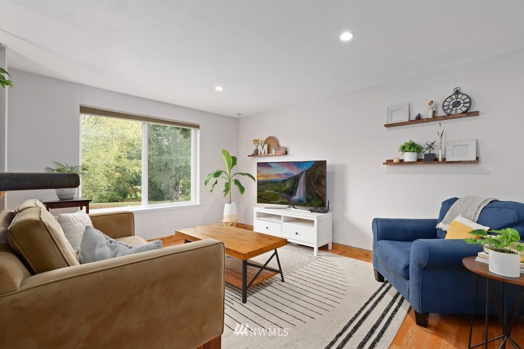 18216 19th Drive Southeast Bothell, WA 98012 - Photo 3 of 37 a living room with furniture and a flat screen tv