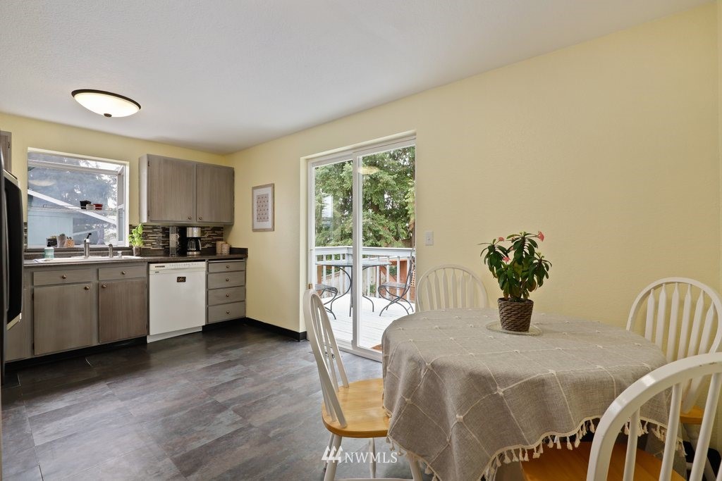18216 19th Drive Southeast Bothell, WA 98012 - Photo 6 of 37 a kitchen with stainless steel appliances wooden floors and white cabinets