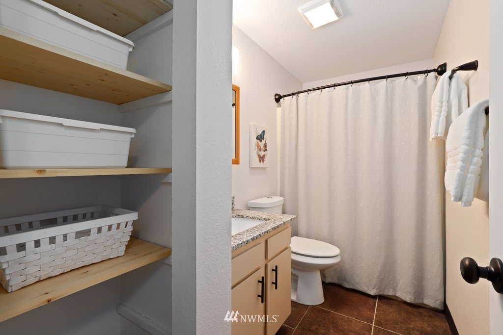 18216 19th Drive Southeast Bothell, WA 98012 - Photo 10 of 37 a bathroom with a toilet a sink and a shower