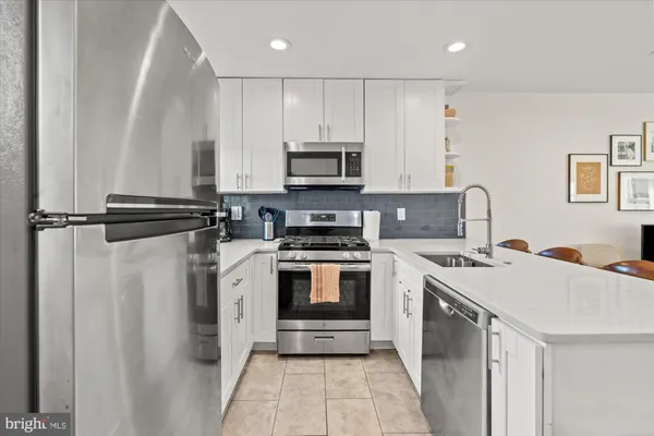 a kitchen with a stove sink and a refrigerator