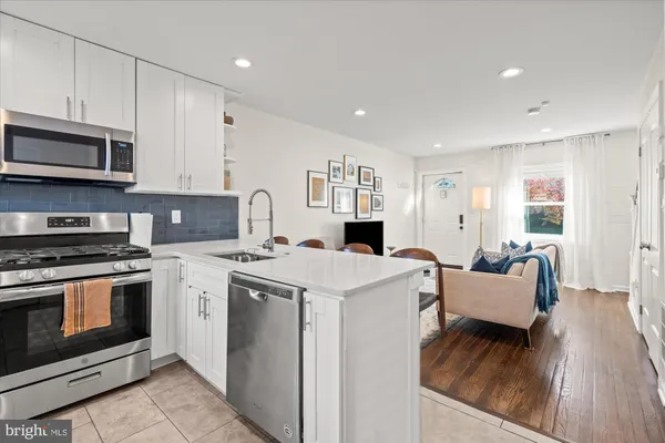a kitchen with stainless steel appliances granite countertop a stove and a refrigerator
