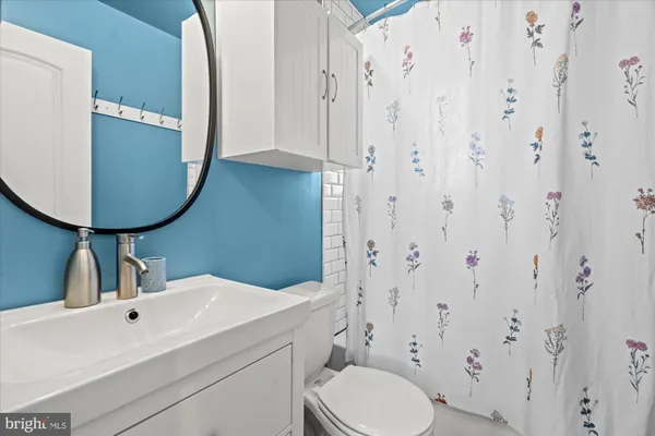 a bathroom with a sink toilet and mirror