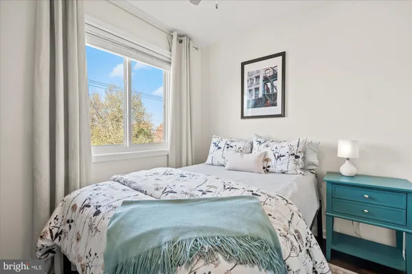 a bedroom with a bed and a window