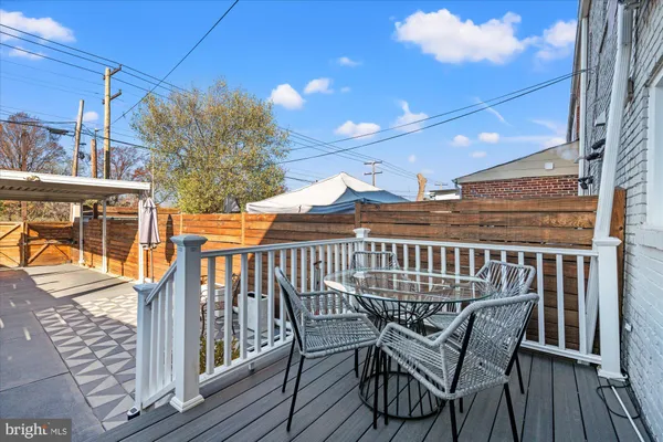a view of a chair and table on the deck
