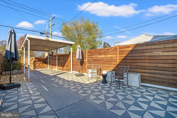 a view of a patio with table and chairs and potted plants