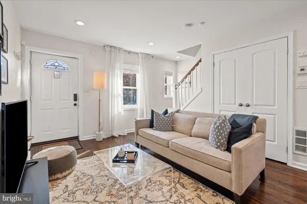 a living room with furniture and wooden floor