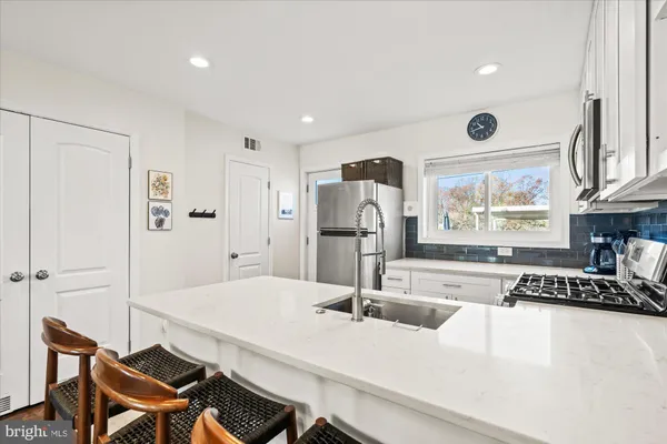 a kitchen with a table and chairs