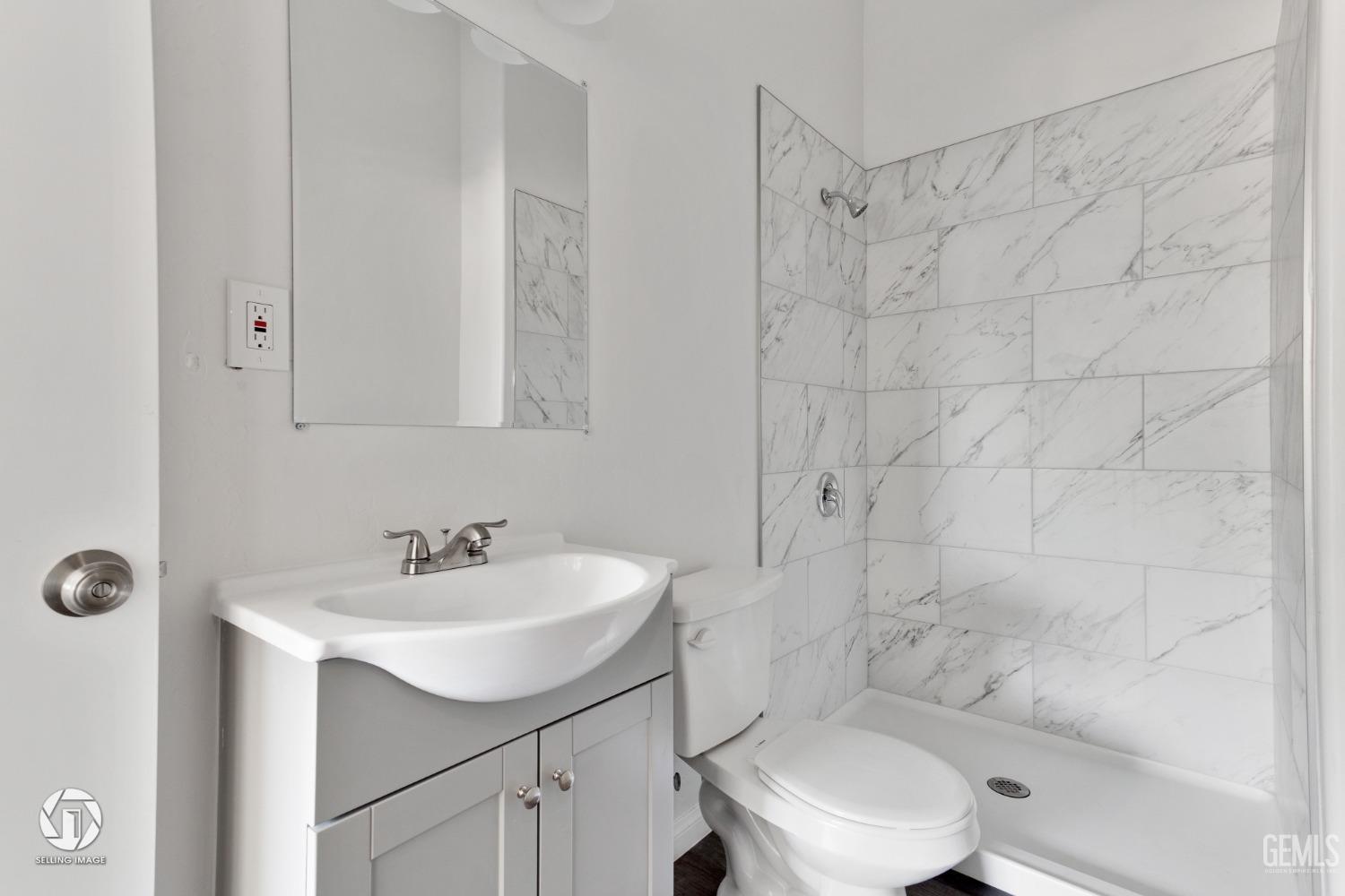 Undisclosed Address Bakersfield, CA 93305 - Photo 15 of 28 a bathroom with a sink a toilet and shower