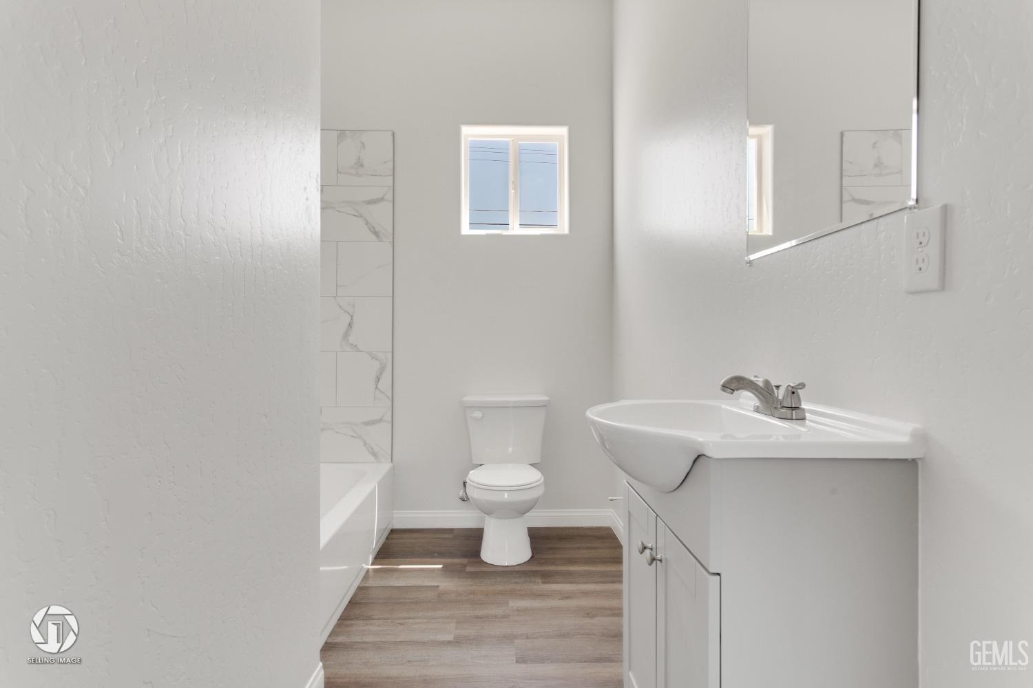 Undisclosed Address Bakersfield, CA 93305 - Photo 17 of 28 a bathroom with a sink toilet and a mirror
