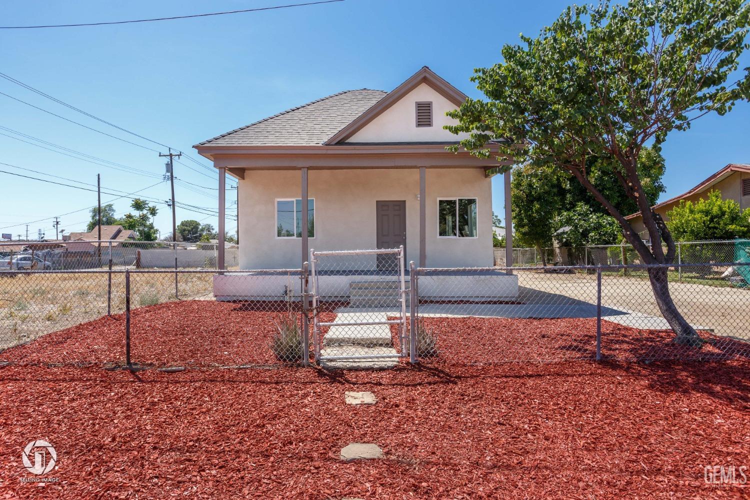 Undisclosed Address Bakersfield, CA 93305 - Photo 3 of 28 a front view of a house with a yard