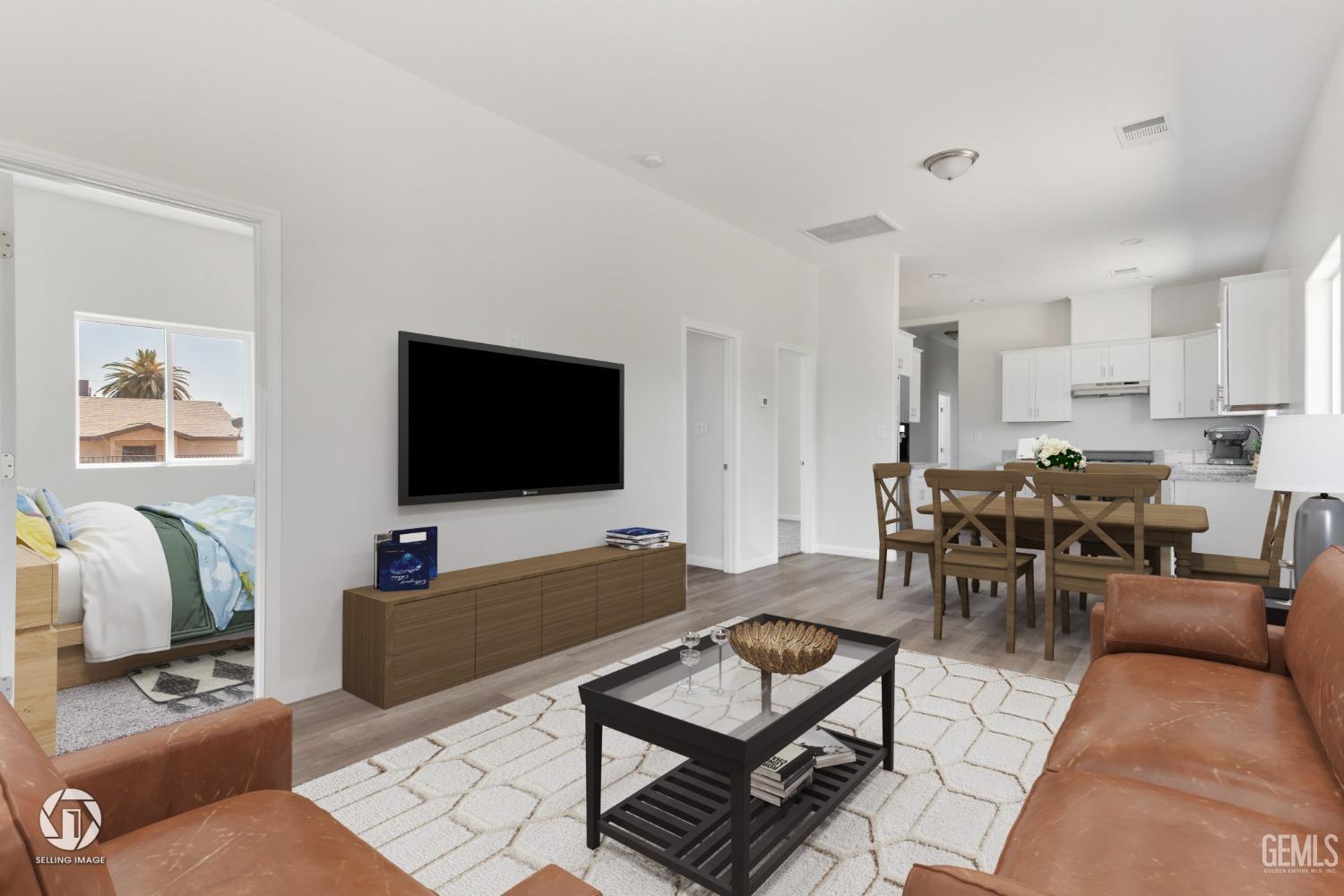 Undisclosed Address Bakersfield, CA 93305 - Photo 8 of 28 a living room with furniture and a flat screen tv