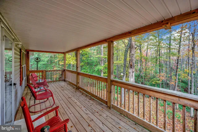 a balcony with furniture and wooden floor